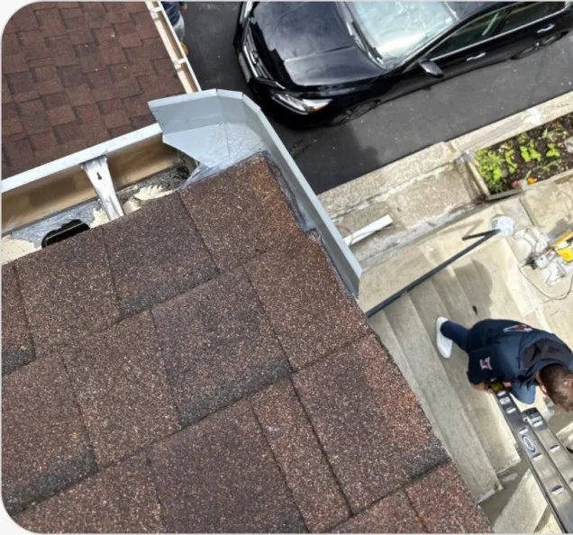 Crew member working on a gutter installation